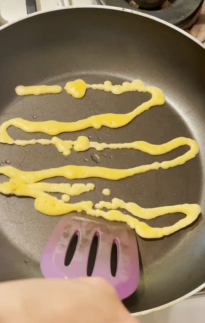 Elf spaghetti cooking in frying pan. 