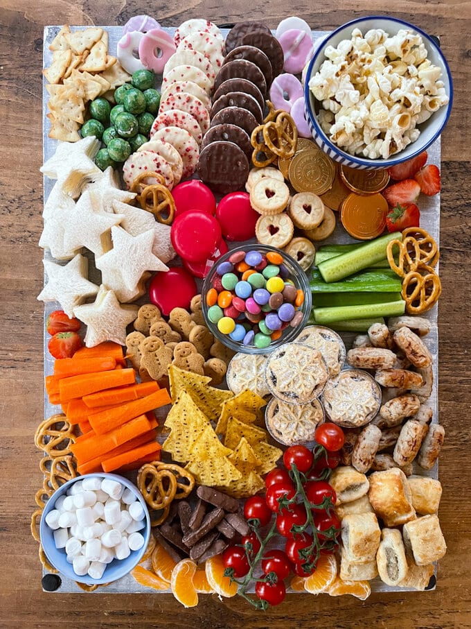 Bright and colorful food arranged on a big rectangle shaped platter. 