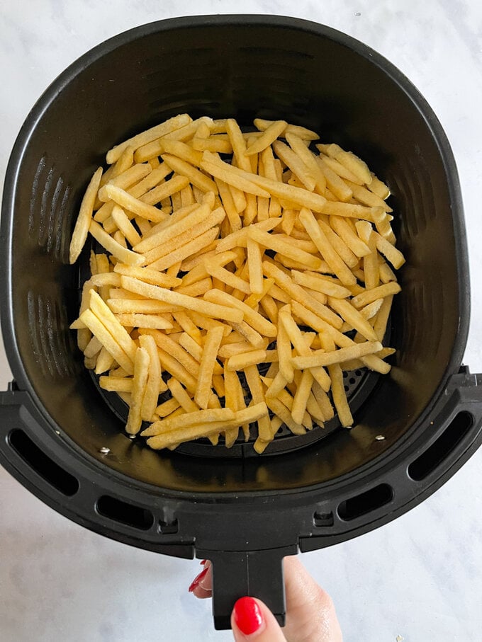 Fries placed in the air fryer ready to be cooked.