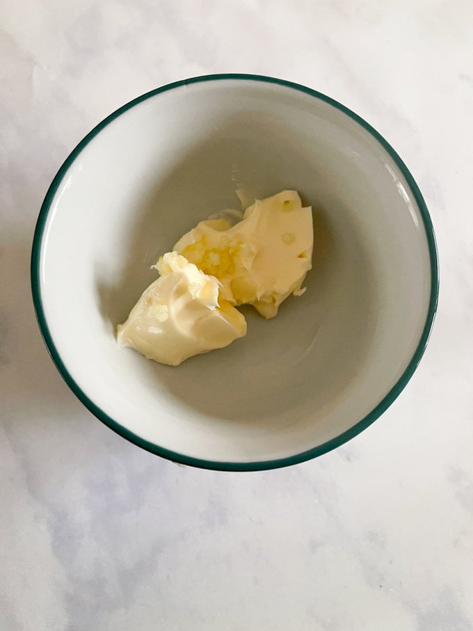 Butter and garlic together in a small bowl.