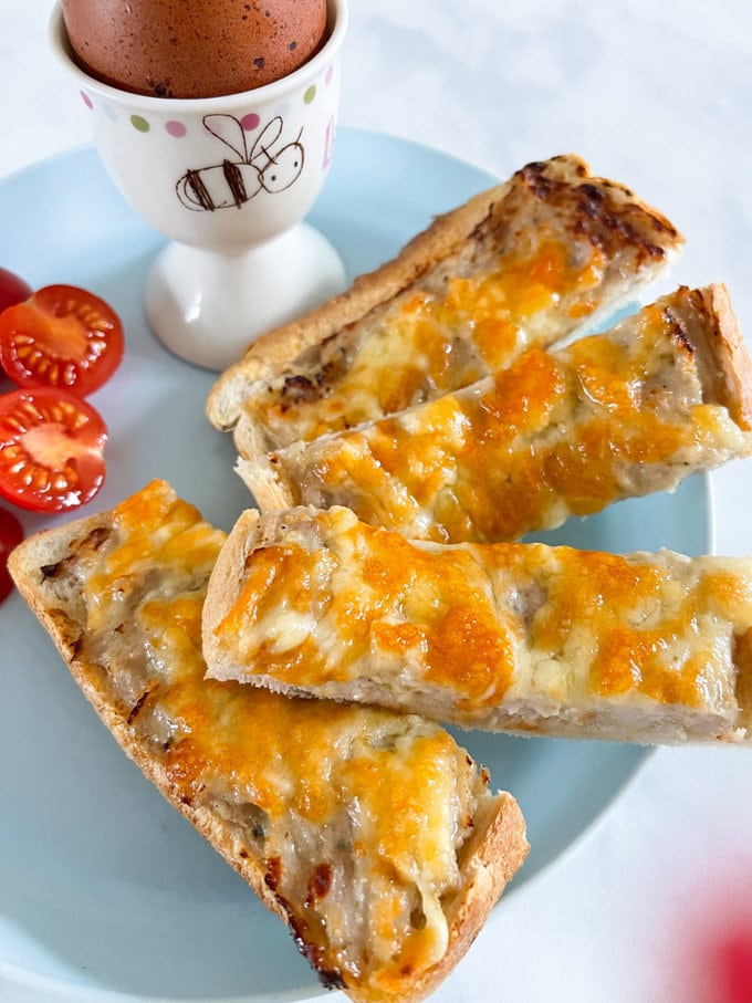 Close up of Airfryer sausage and cheese soldiers on a plate.