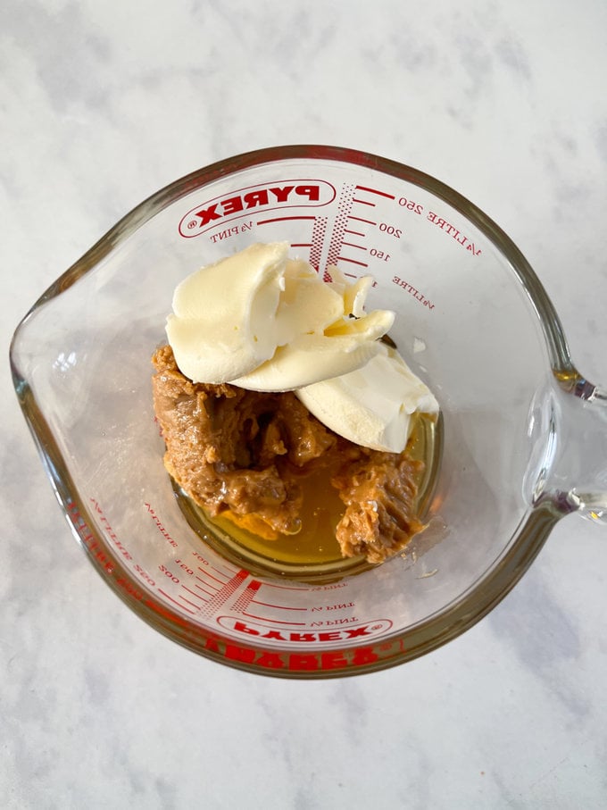 Peanut butter, Honey and butter in a small pyrex jug.