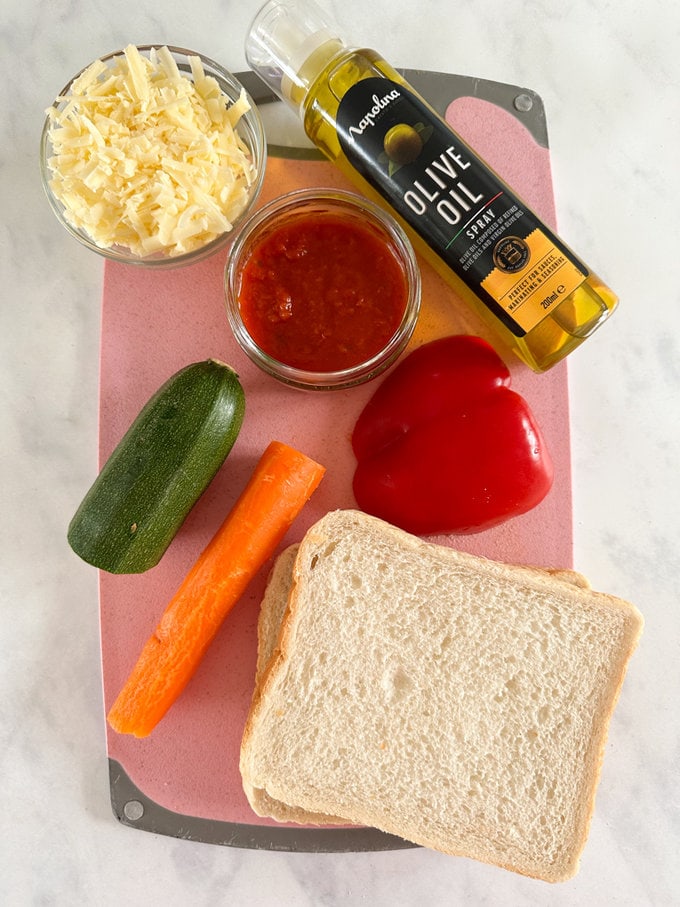 Ingredients arranged on a pink chopping board.