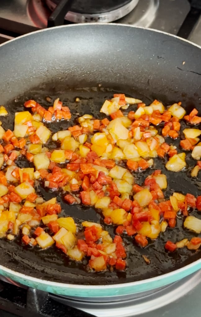 Ingredients added to a frying pan.