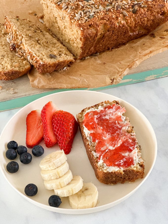 porridge bread served in a bowl topped with fresh fruit