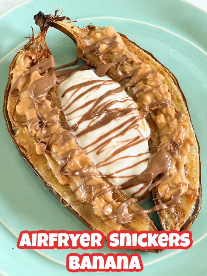 Airfryer Snickers Banana served on a blue plate and topped with peanut butter, melted chocolate and greek yogurt