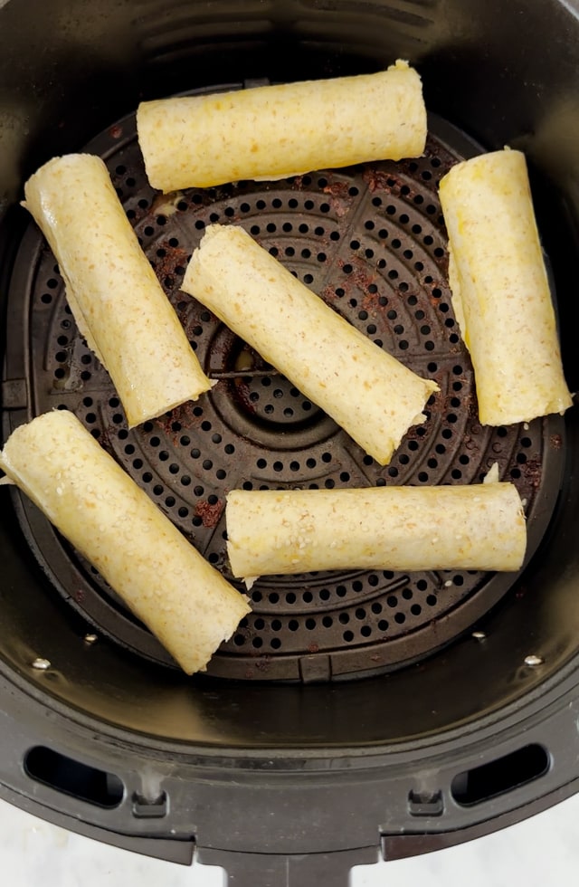 Once sausages rolled up into a wrap all get placed back into the airfryer.