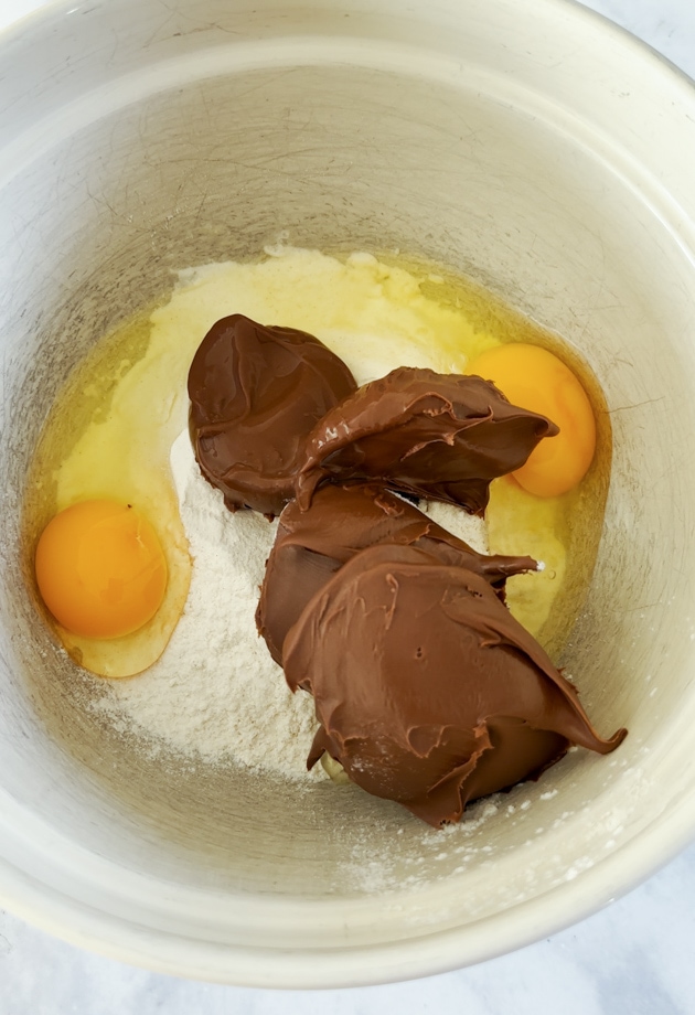 All the ingredients being combined in  a large mixing bowl. 