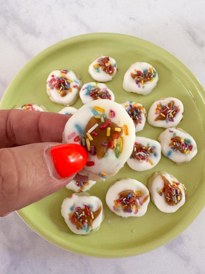 Smashed frozen banana bites on a green plate