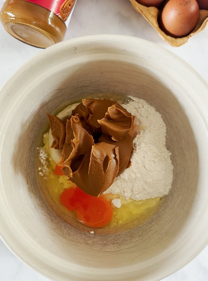 Ingredients being added to a mixing bowl.