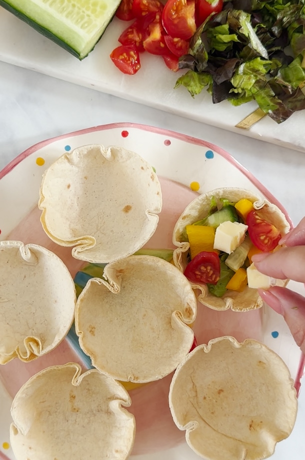 Ingredients being added to cups.