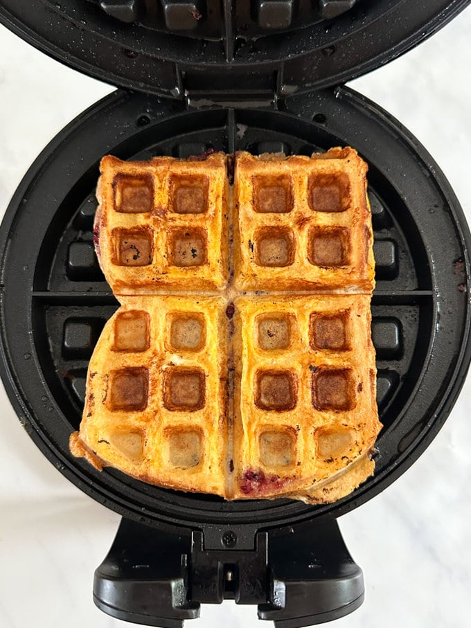 Waffle french toast cooked in the waffle maker, looking all golden brown.