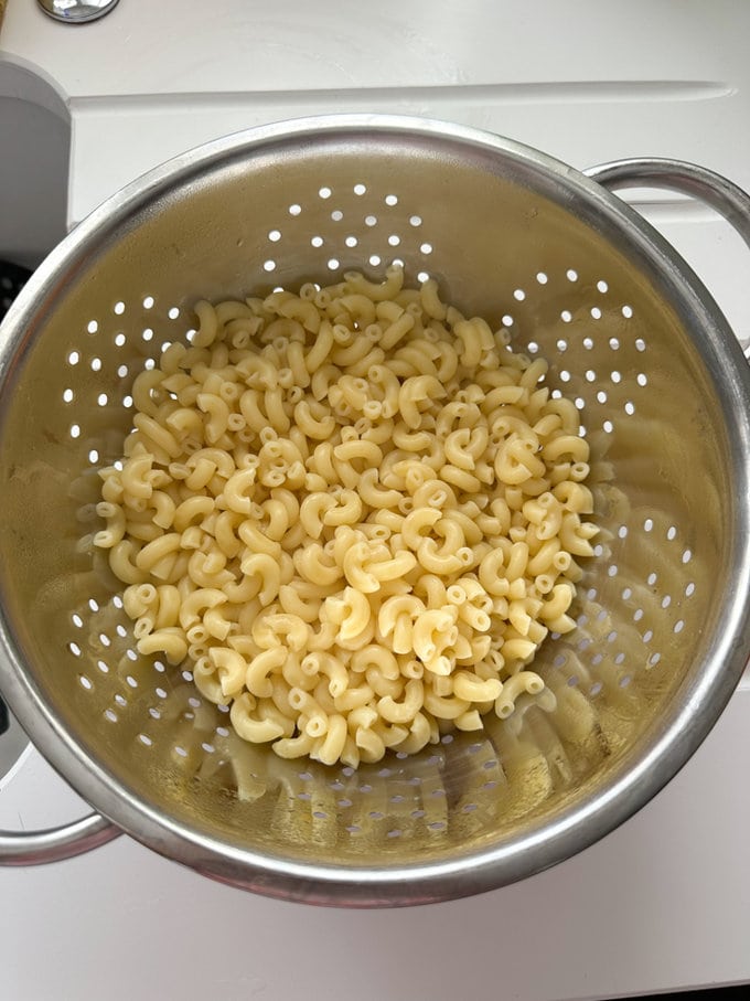 Pasta draining in  a colander. 