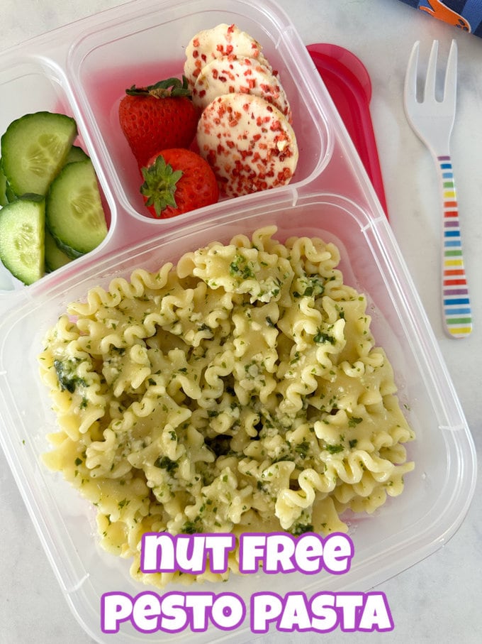 Nut free pesto pasta in a three compartment lunchbox with cucumber, strawberries and rice cakes.