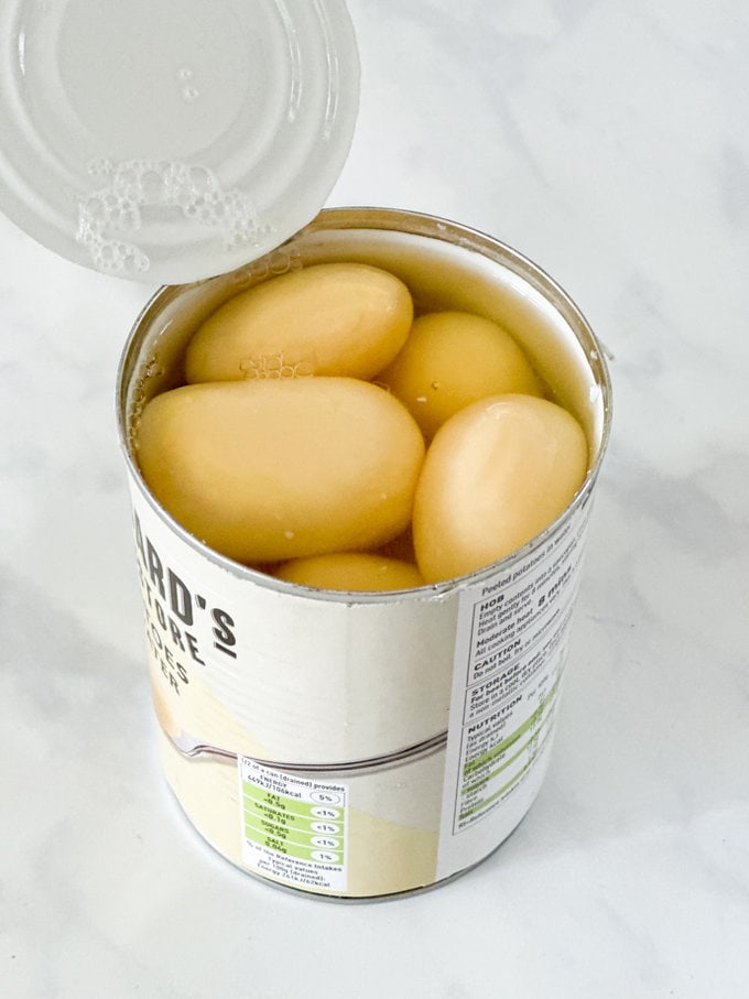 Tinned potatoes being opened.