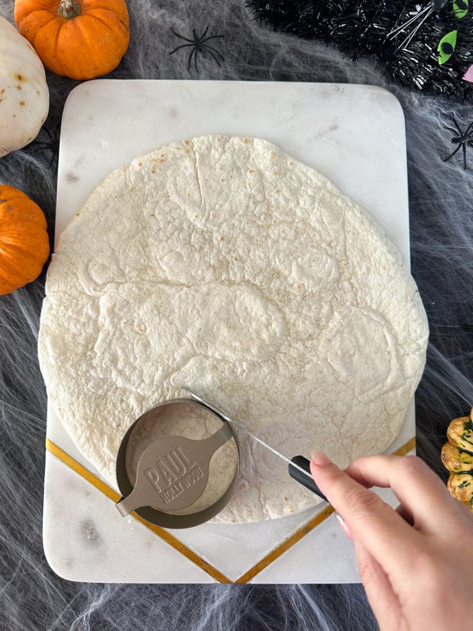 Circle shaped being made on the wrap using a round pastry cutter.