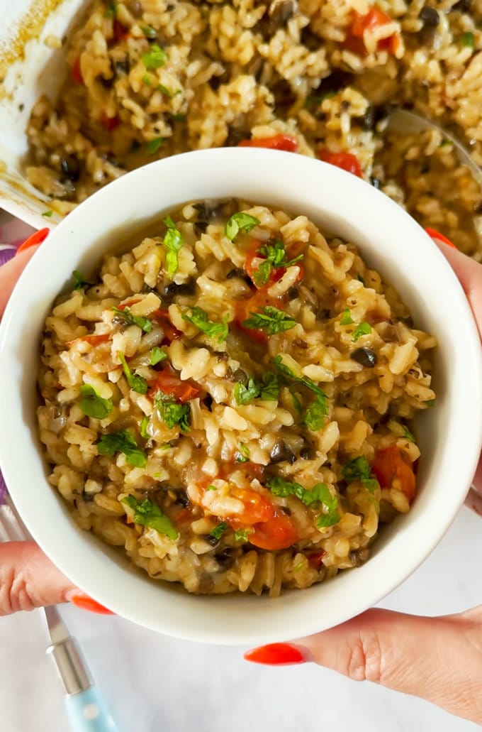 Close up photo of the baked mushroom risotto served in a small white round bowl.