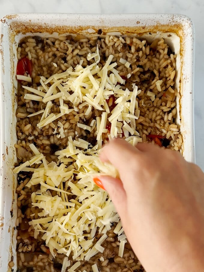 Grated cheese being added.