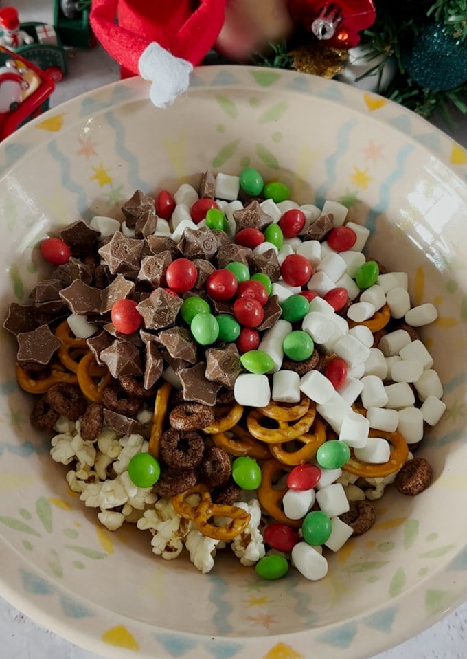 Trail mix in a mixing bowl being prepared.