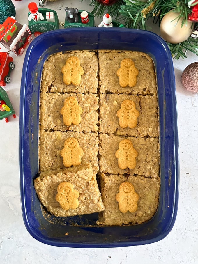 Gingerbread oats cakes divided into eight identical pieces and topped with a small gingerbread biscuit decoration.