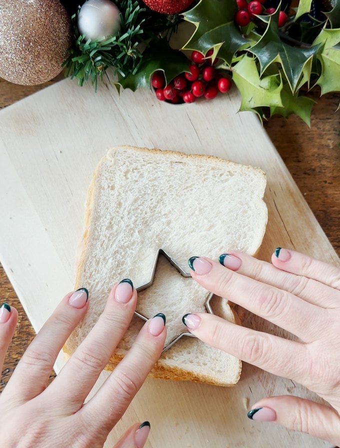 Star shapes being cut out of the sandwich using a star shaped pastry cutter.