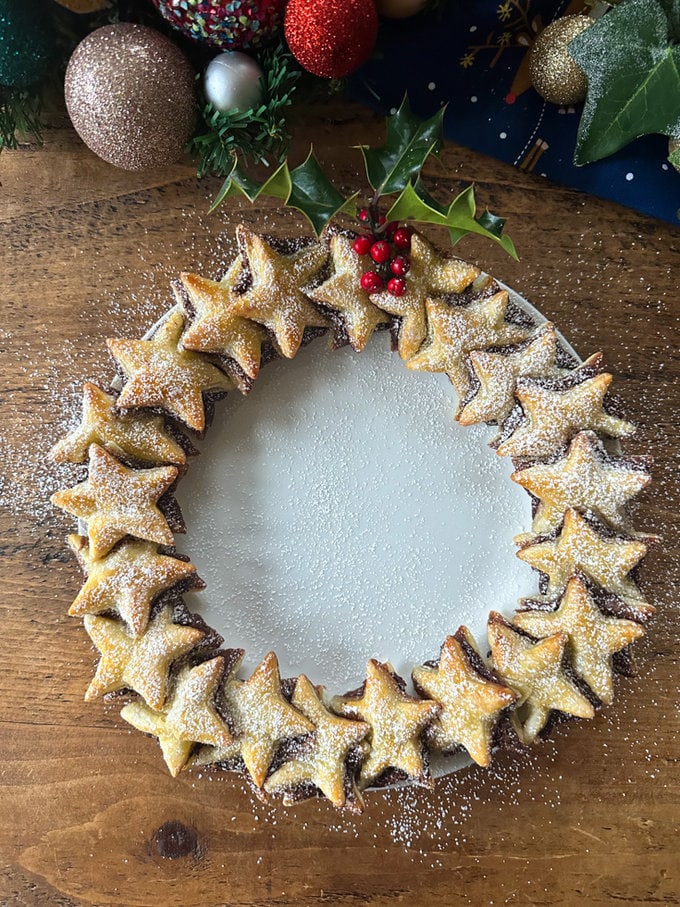 Nutella Puff Pastry Star Wreath presented on a white plate with a light dusting of icing sugar.
