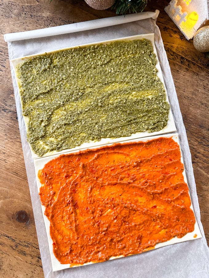 Pesto spread onto the pastry sheets.