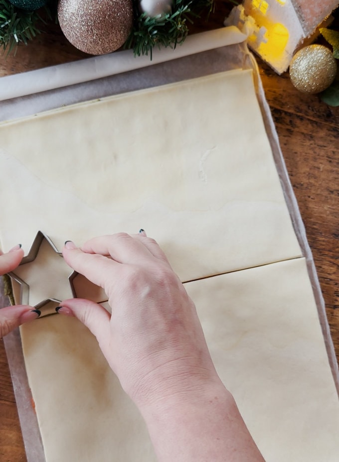 Star shapes being cut out of the pastry using a star shaped pastry cutter.