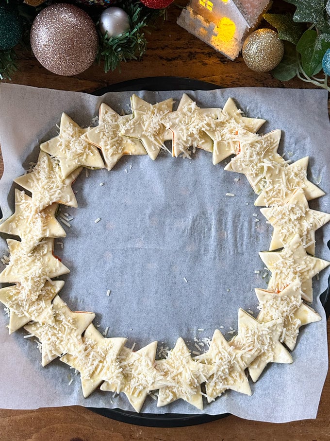 Wreath all ready for the oven, and top with grated parmesan.