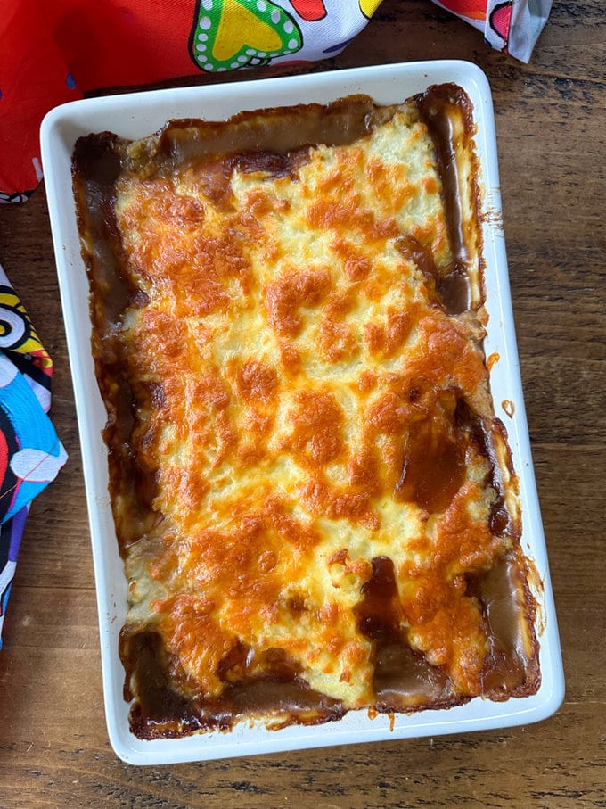 Sausage pie just out of the oven,served in a large,white rectangle oven proof dish.