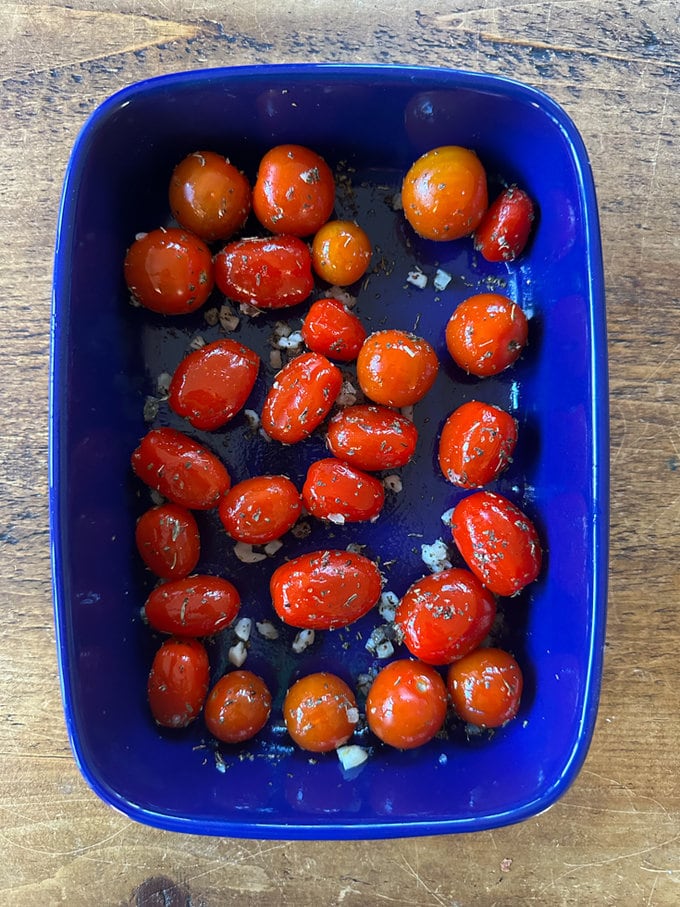 prepped Tomatoes in blue oven dish. 