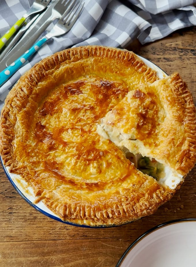 Easy chicken pie in  round pie dish, and cut into portions ready to serve.