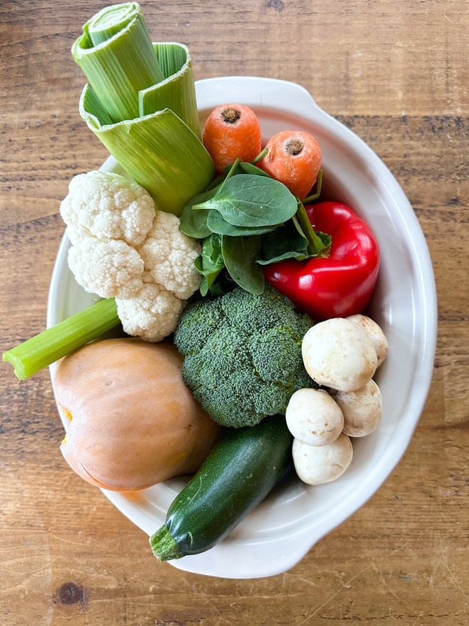 All the ten different raw veggies in the slow cooker, ready for cooking.