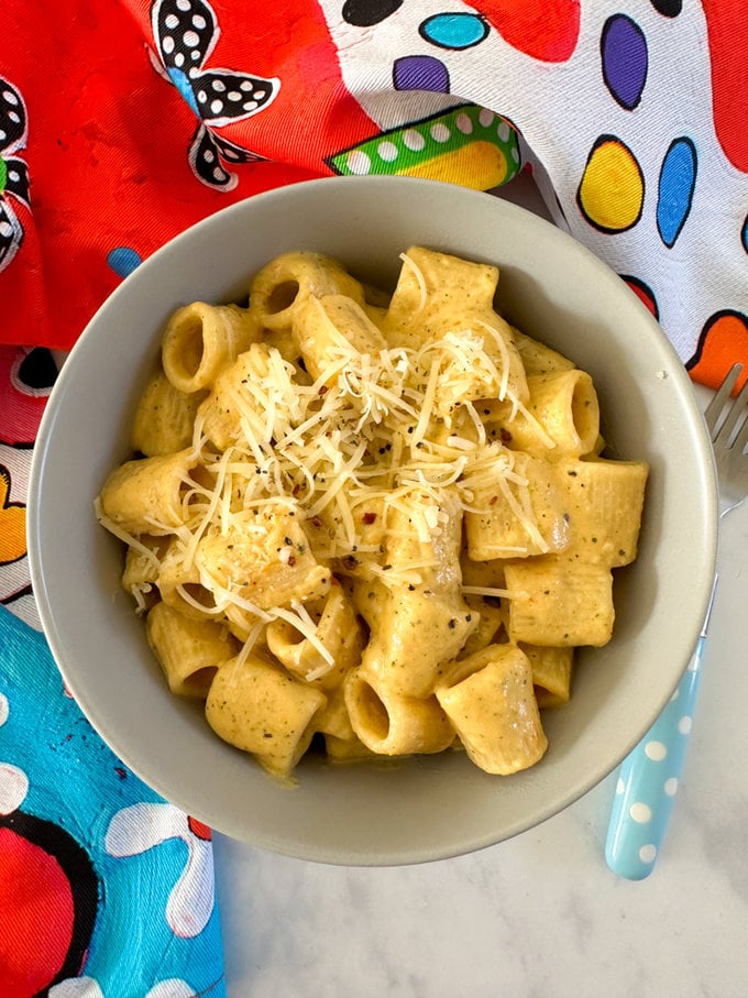 Airfryer Creamy Hidden Veg Pasta Sauce
served in a bowl and garnished with grated cheese.