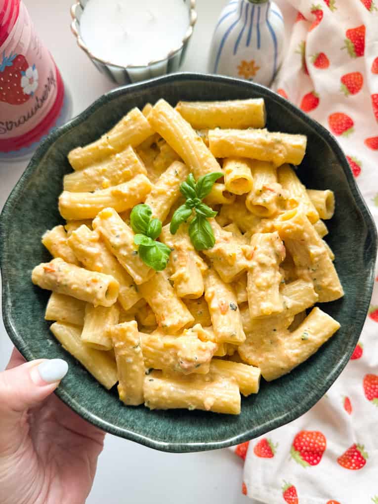 Airfryer Creamy hidden veg pasta sauce served over tube pasta shaped and garnished with a sprig of basil.
