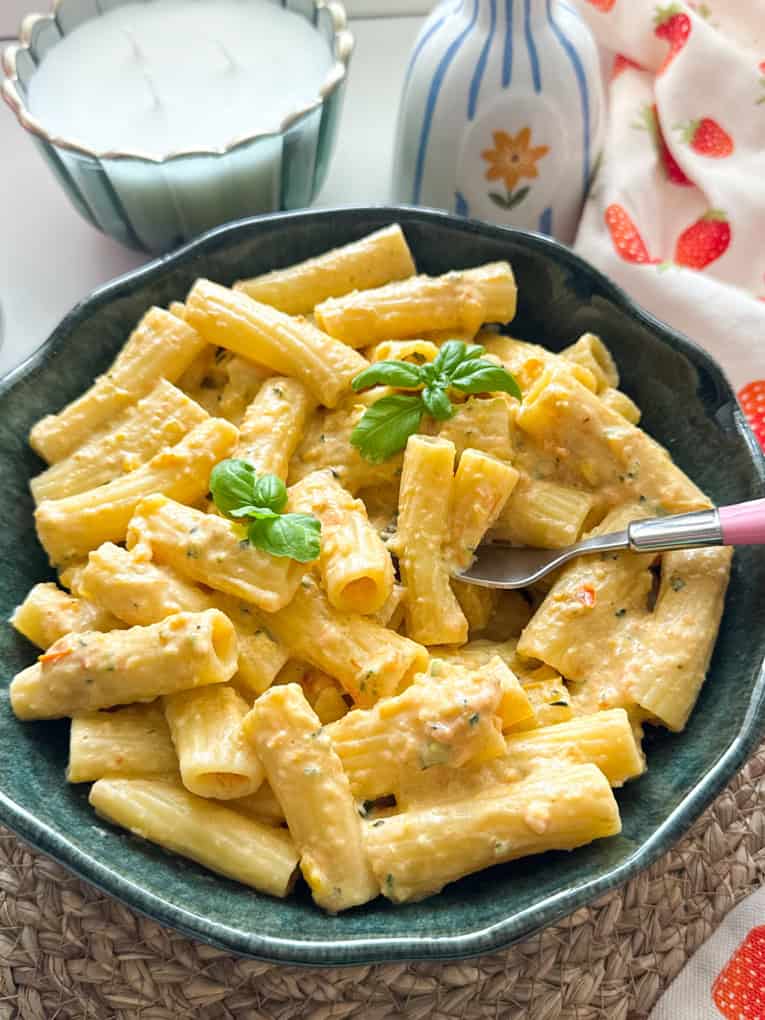 Airfryer Creamy hidden veg pasta sauce served over tube pasta shaped and garnished with a sprig of basil.