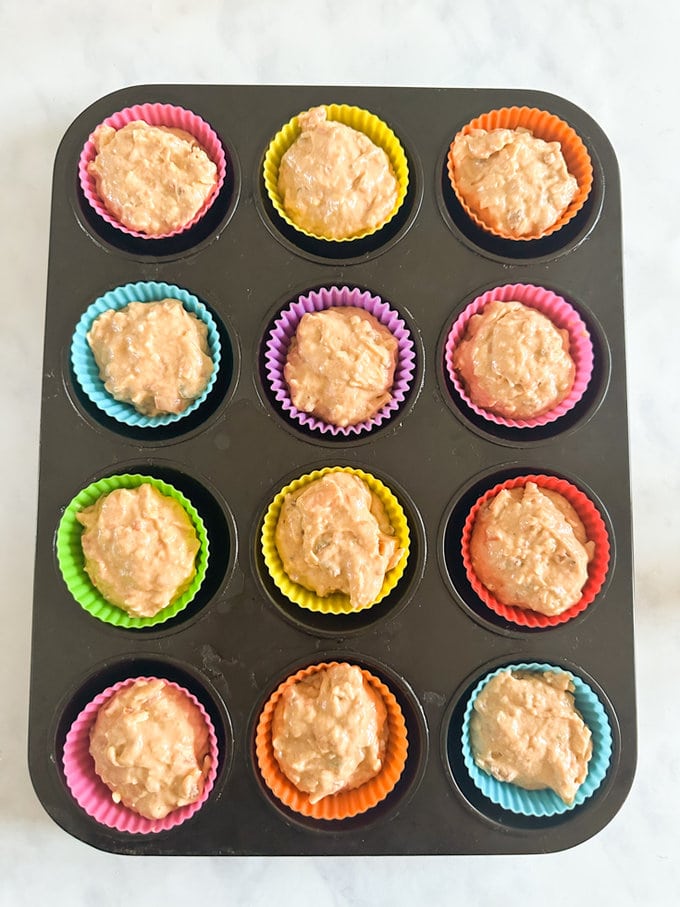 Colorful Filled muffin cases ready for the oven.
