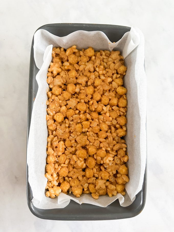 Ingredients added to a lined loaf tin and pressed down with the back of a spoon to make it as compact as possible.