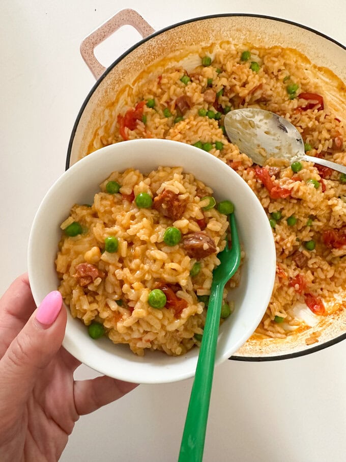 Baked Chorizo Cheese Risotto served in a small white bowl with a bright green fork.