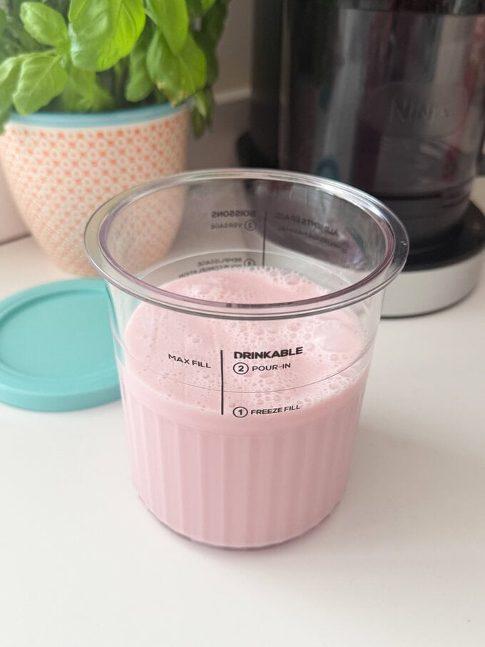 Milkshake ingredients in a ninja clear pot.