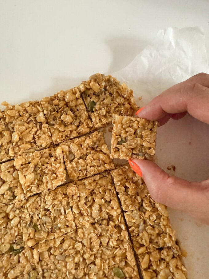 Mini No Bake Granola Bites being cut up into small bite size pieces.