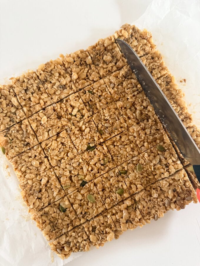 Mini No Bake Granola Bites being cut up into small bite size pieces.