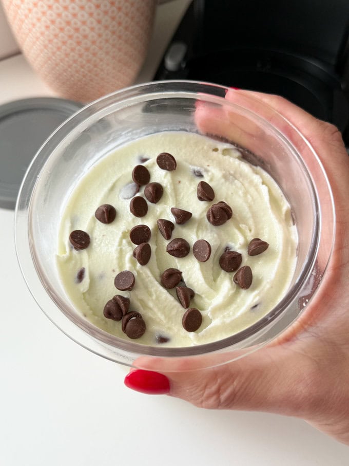 Homemade Mint Choc Chip Ice Cream made in the Ninja Creami sprinkled with chocolate chips.