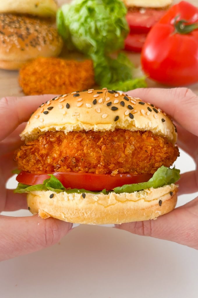 The most delicious homemade crispy chicken burgers. Made with a cornflake coating for extra crunch and oven baked to keep them super healthy. Served in a seeded burger bun with fresh slices of tomato and lettuce leaves.