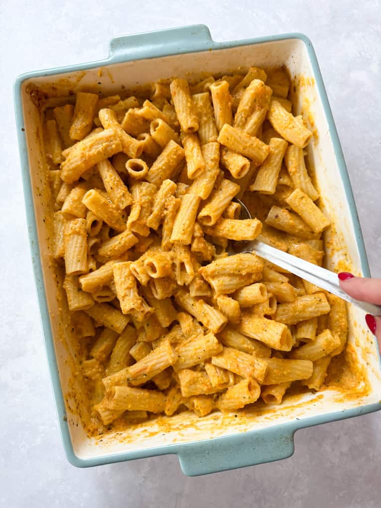 Roasted Veg & boursin pasta served in a baby blue oven dish.