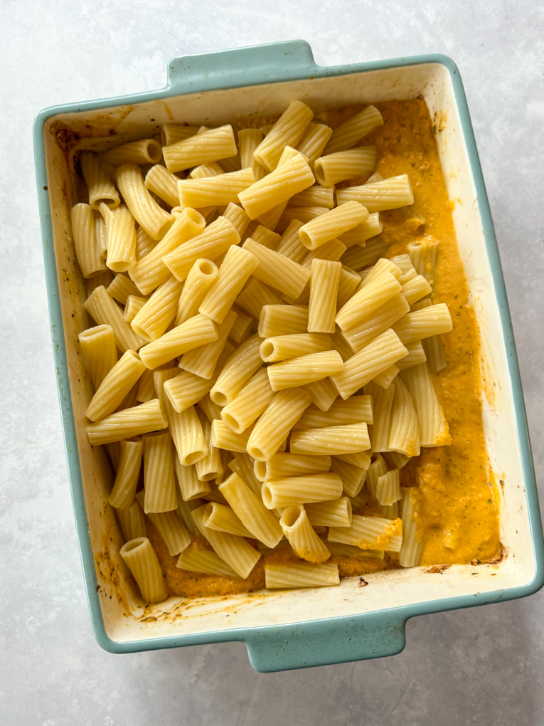 Roasted Veg & boursin pasta served in a baby blue oven dish.