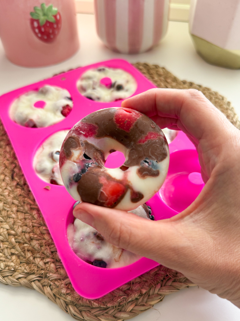 Frozen berry donut just taken out of the bright pink donut silicone mould