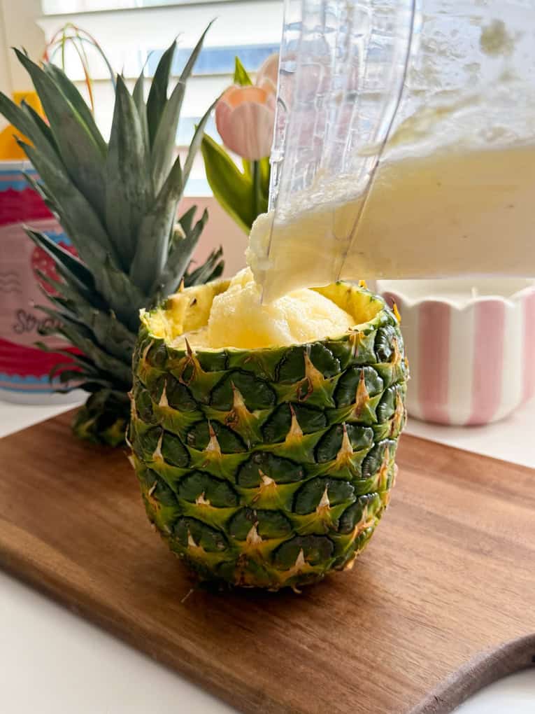 Slushie being poured into the fresh pinnapple.