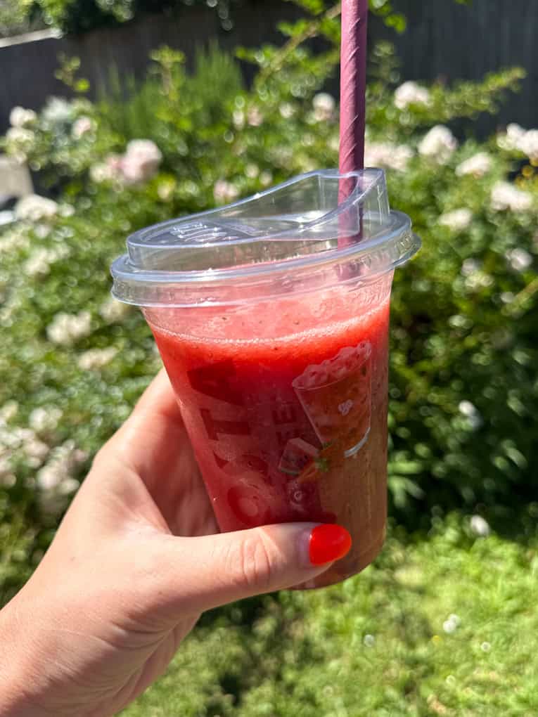 Strawberry, Watermelon & Mint Refresher served in a clear Costa plastic cup with a straw.