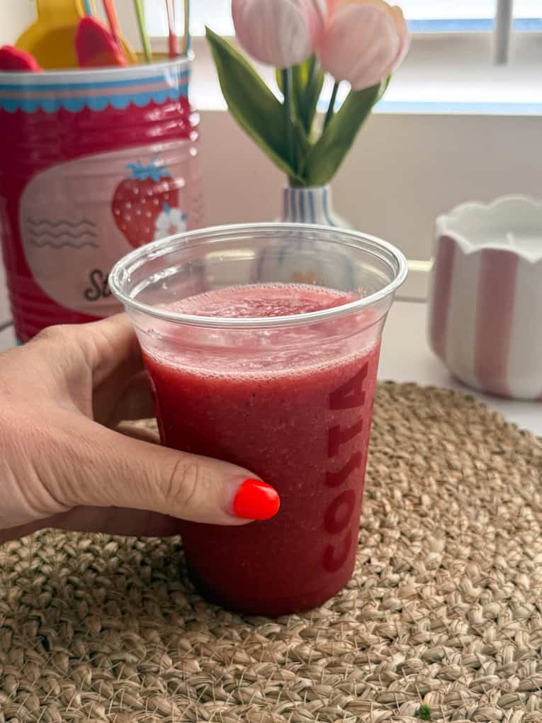 Strawberry, Watermelon & Mint Refresher served in a clear Costa plastic cup with a straw.